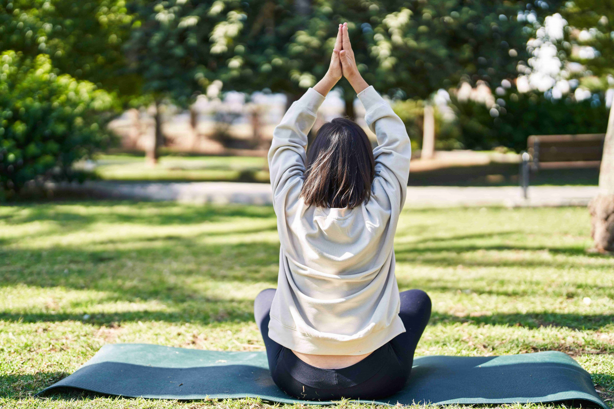 Jeune fille faisant du yoga dehors pour déstresser avant son permis B